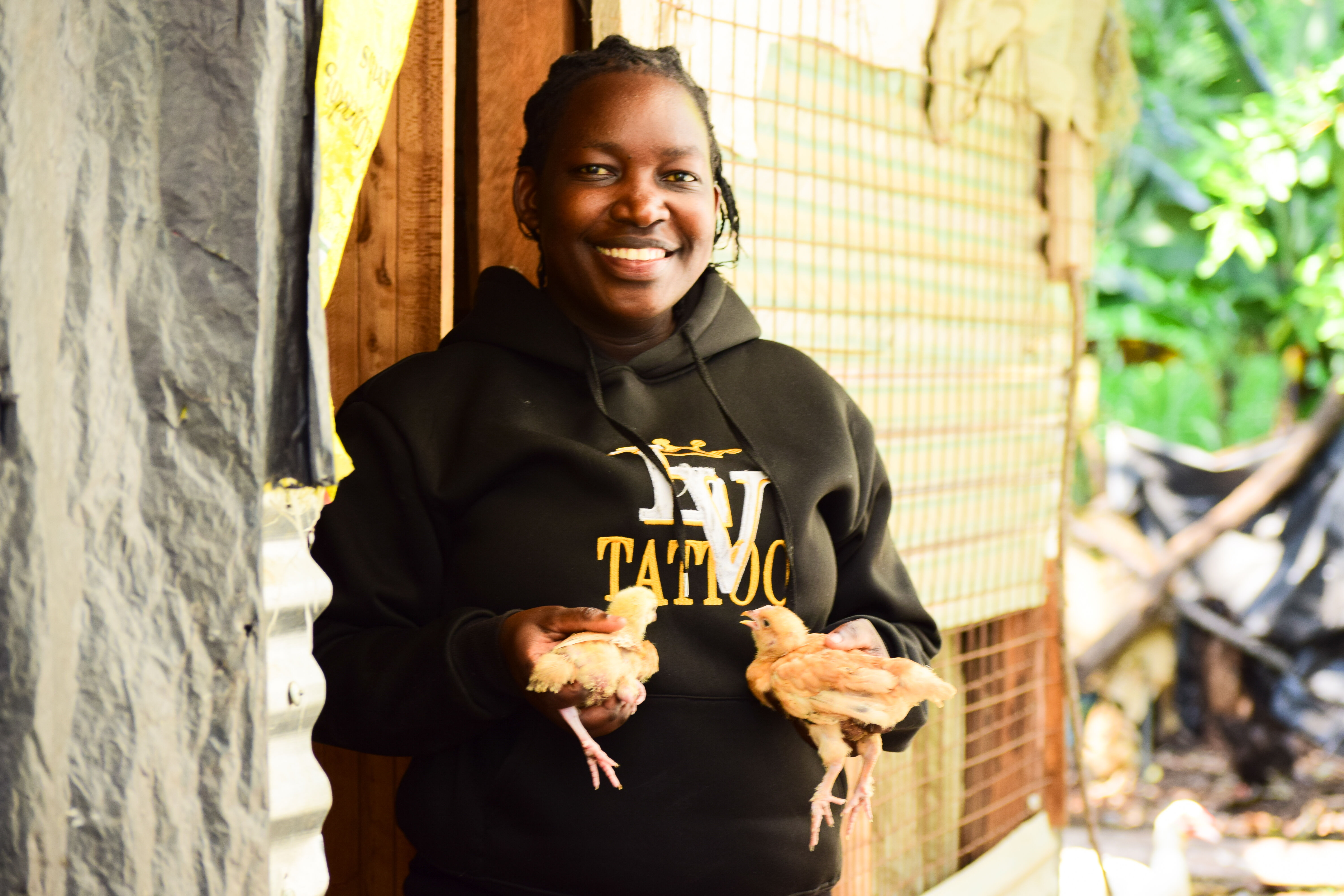 Rebecca Odalo with her poultry flock in Malaba Central Ward, Busia County